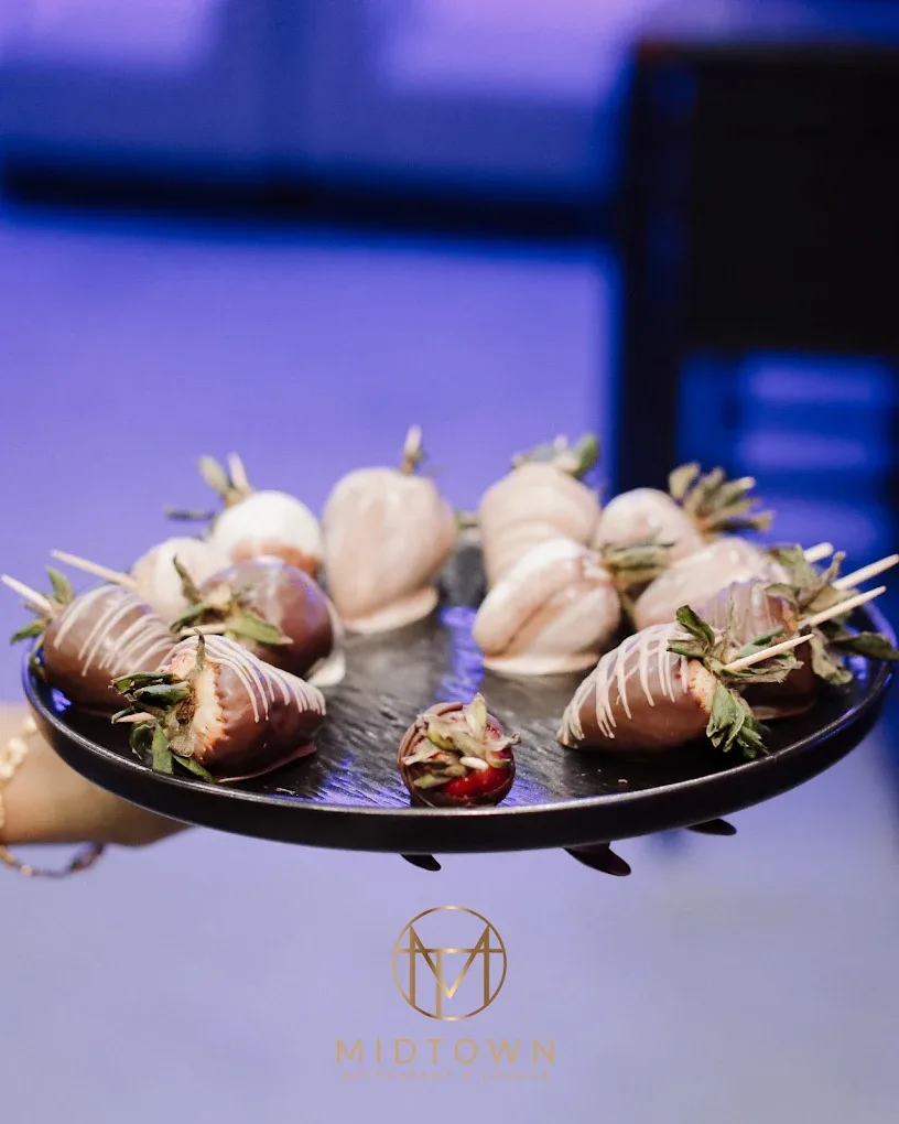 Chocolate dipped strawberries carried to the table